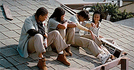 Jada Pinkett, Queen Latifah, Vivica A. Fox, and Kimberly Elise sitting on a roof laughing (from Set it Off) 